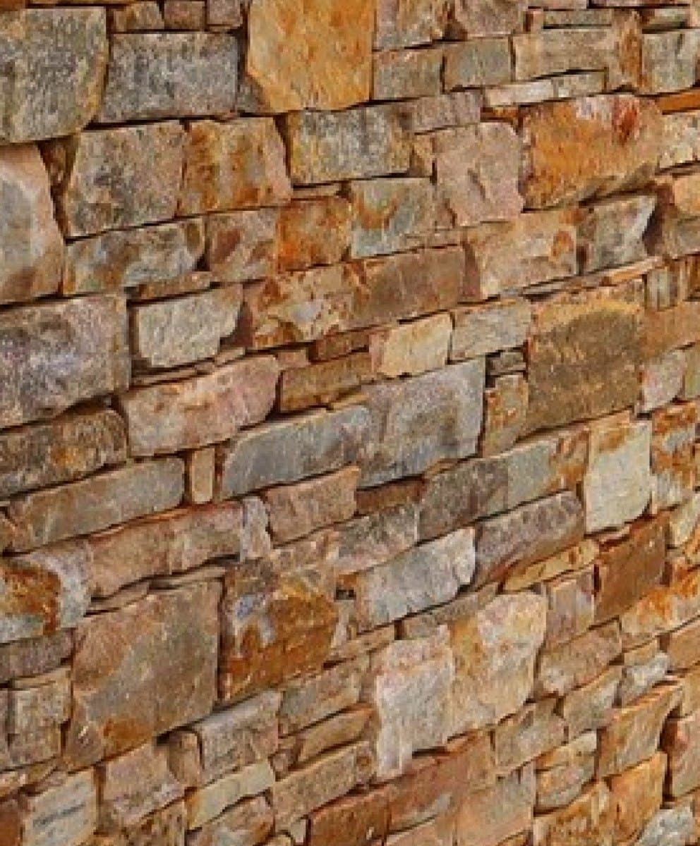 Close-up of a built Toodyay Stone wall, hand-laid blocks showing the quartzite's natural fault lines and warm weathering